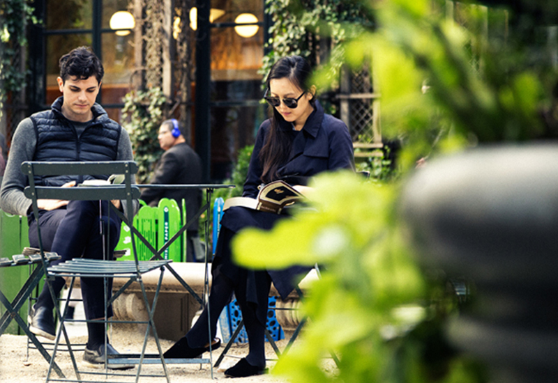 A Couple Enjoys Reading at Their Outdoor Cafe Table