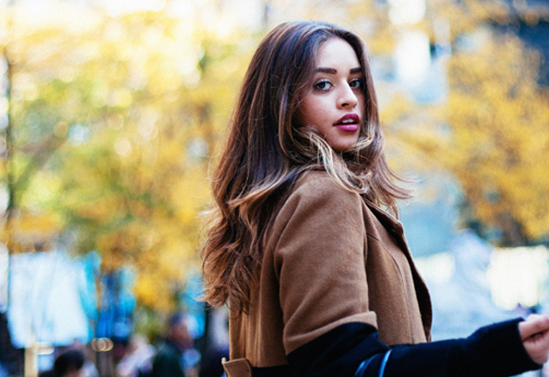 Brunette Model Wearing Brown Coat Looking Into Camera