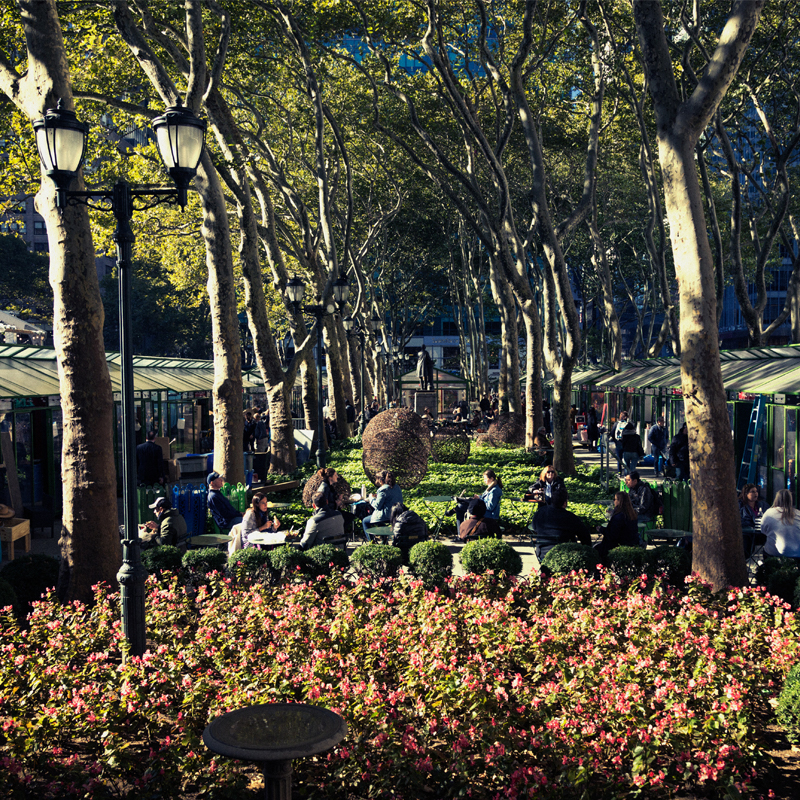 A Crowd of People Utilize a Beautiful Outdoor Courtyard in Bryant Park